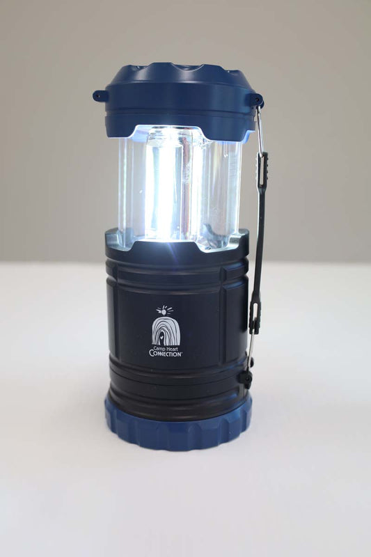 photo of lantern with white chc logo open and lit up