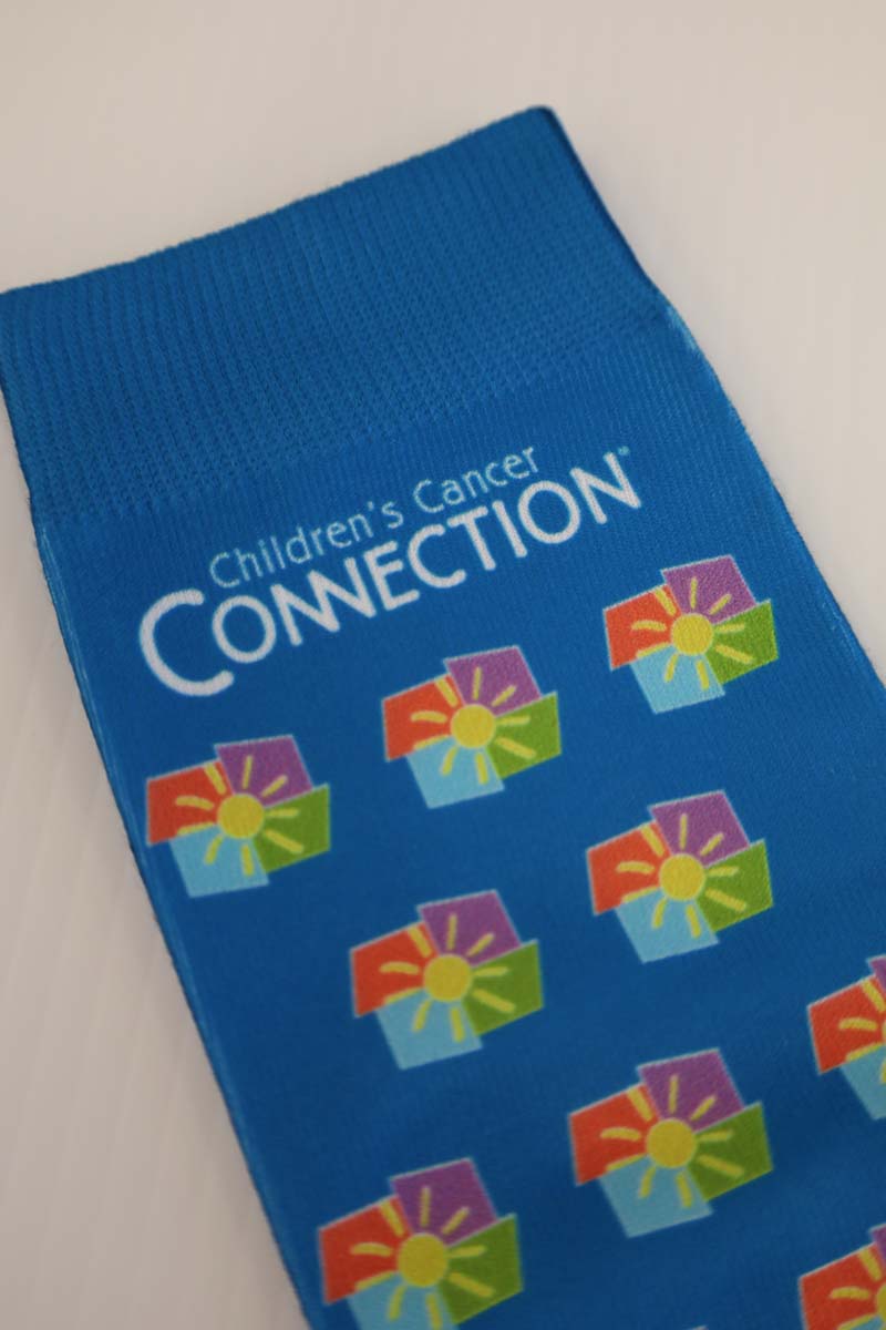 photo of blue socks with full color ccc logo scattered