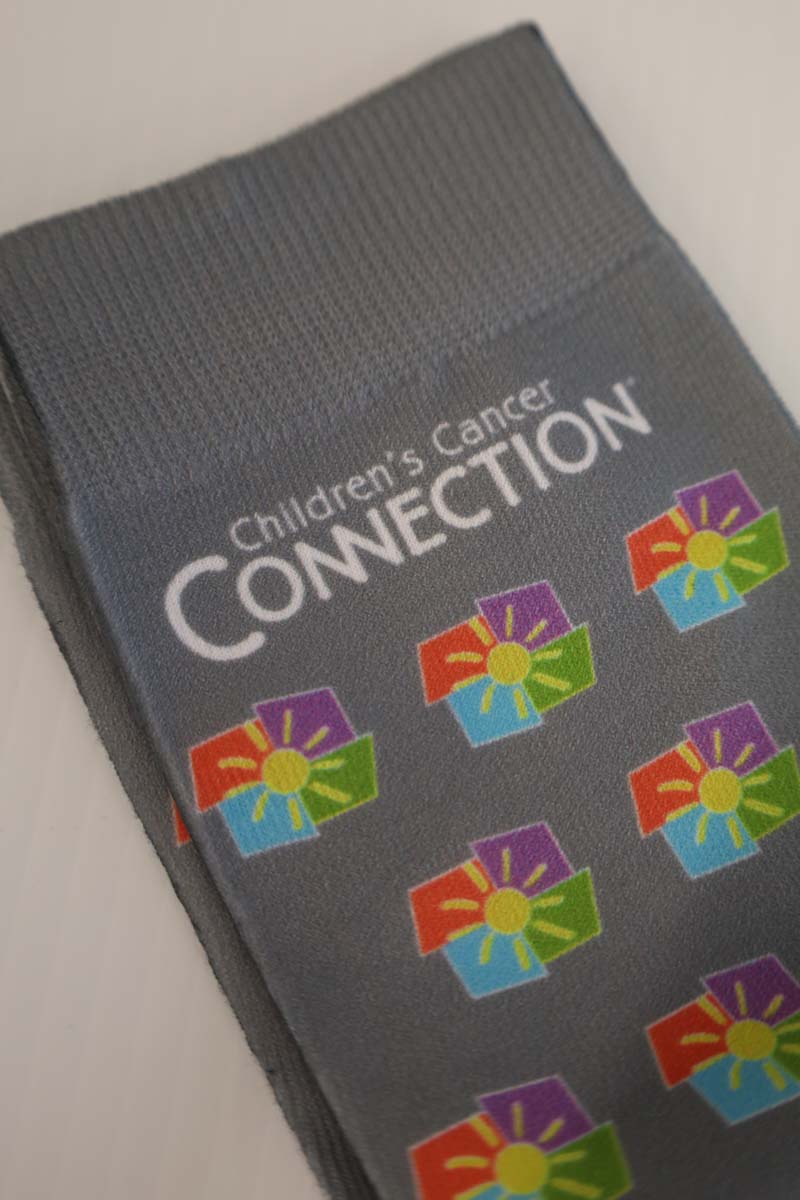 photo of grey socks with full color ccc logo scattered