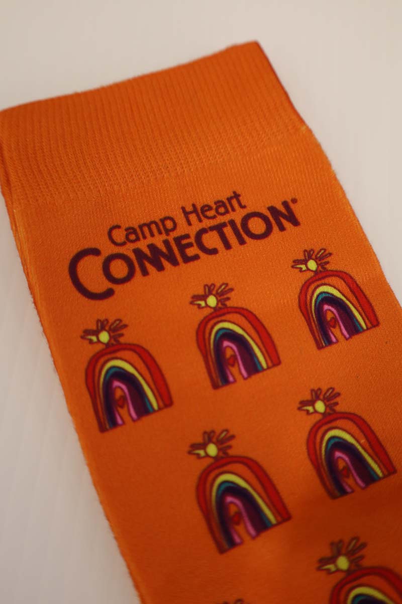 photo of orange socks with full color chc logo scattered